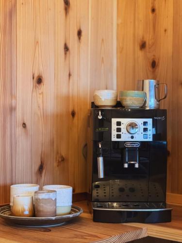 a microwave oven with bowls on top of it at Inaka Lodge - Countryside Stay in Nakano