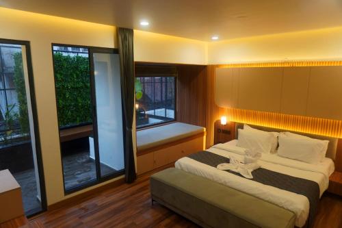 a bedroom with two beds and a window at The Lovedale Kodaikanal Stay & Hotel in Kodaikānāl