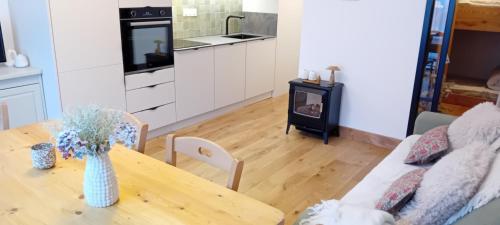 a kitchen and dining room with a table and a stove at Balcons G 013 - PARC NAT VANOISE appart 8 pers in Termignon