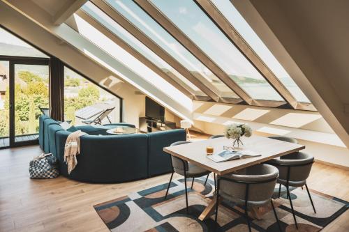 a living room with a couch and a table at Villa Caroline, Lac d'Annecy in Duingt