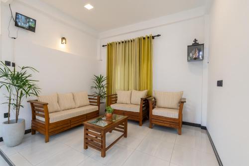 Una sala de estar con dos sofás y una mesa de café. en Skyport Villa Katunayaka, en Katunayake