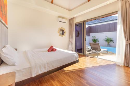 a bedroom with a large bed and a patio at New Boutique Pool Villa Sequoia Close to Rawai and Naiharn Beach in Rawai Beach