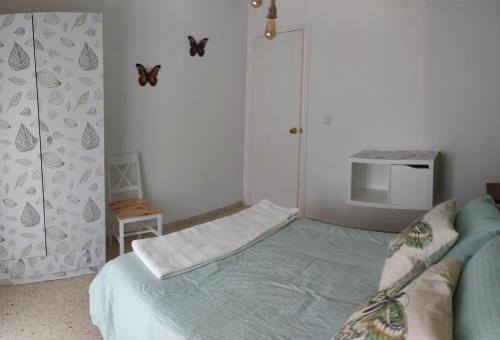 a small bedroom with a bed and a tv at Pet Friendly Apto El Sendero in El Bosque