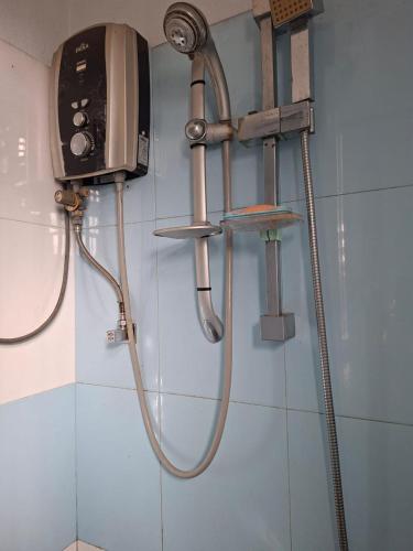 a shower in a bathroom with a shower head at ADLi in Belihuloya