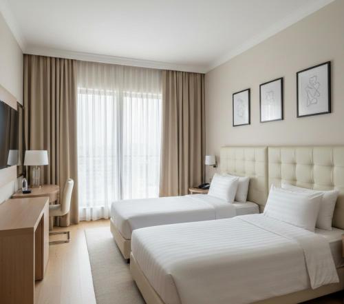 a hotel room with two beds and a desk at Görgülü Apart 06 in Mamak