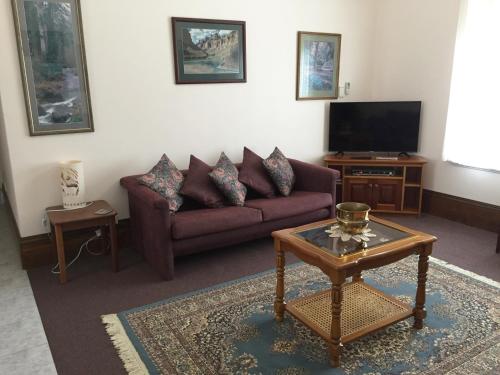 a living room with a couch and a coffee table at Aarn House B&B Airport Accommodation in Perth