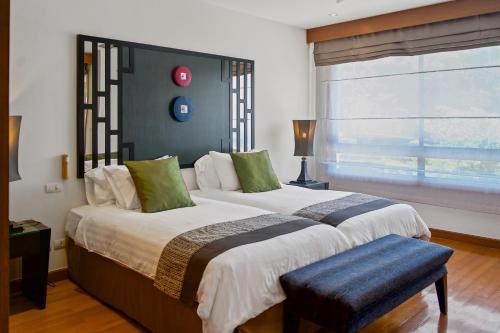 a bedroom with a large bed with a large window at Luxury Pool Villa Laguna Resort Near Layan Beach - 2 bedrooms 6 people in Layan Beach