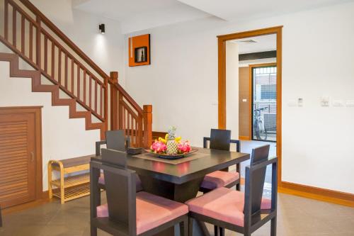 a dining room with a table and chairs at Laguna Luxury 2-Bed Pool Villa - Near Layan Beach in Layan Beach