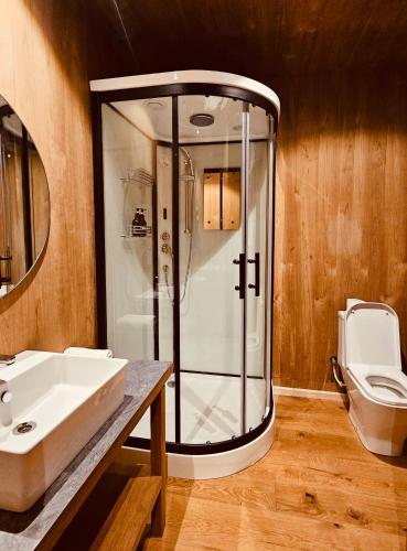 a bathroom with a shower and a sink and a toilet at The Himalayan Tyangboche in Thyāngboche