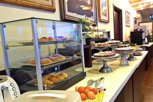 a bakery with a display case filled with pastries at Hotel Gabbiano in Mola di Bari