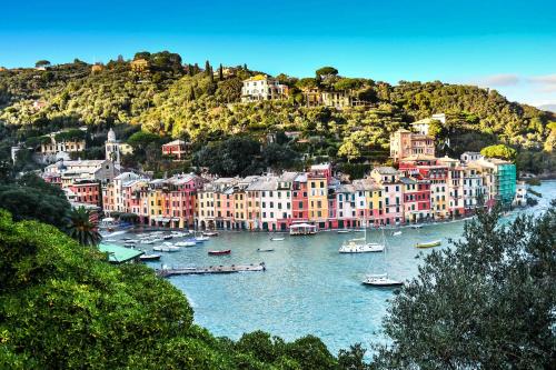a group of boats in a river with buildings at PLAN SEA Guest House in Santa Margherita Ligure