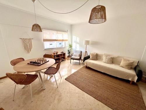 a living room with a couch and a table at Miguel Surf House in Costa da Caparica