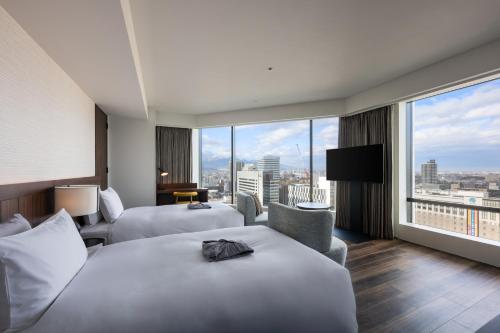 Ένα ή περισσότερα κρεβάτια σε δωμάτιο στο The Gate Hotel Sapporo by Hulic