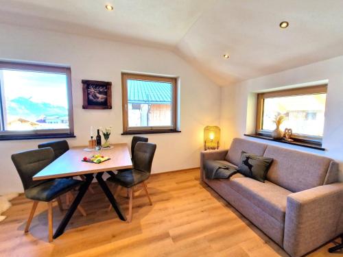 a living room with a couch and a table at Apartment Wildschütz by Interhome in Weerberg