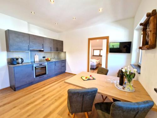 a kitchen and dining room with a wooden table at Apartment Wildschütz by Interhome in Weerberg