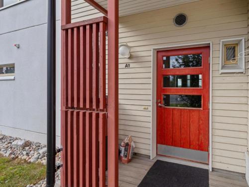 a red door on the side of a house at Holiday Home Rantala 2 by Interhome in Ranua