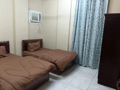 Llit o llits en una habitació de بناية هند