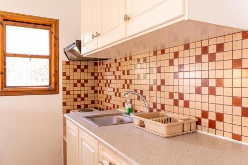 a kitchen counter with a sink and a window at Amalia Studios Skiathos in Skiathos Town