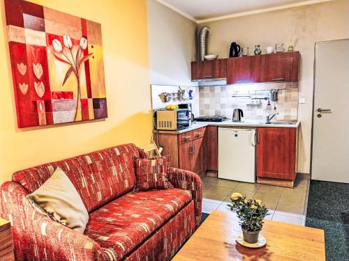 a living room with a couch and a kitchen at Studio Čertovka-3 by Interhome in Harrachov