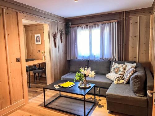a living room with a couch and a table at Apartment Edelweiss-Stube by Interhome in Klosters Serneus
