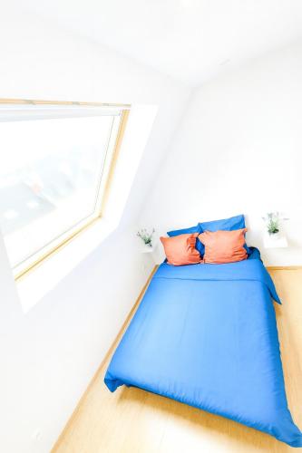 a bed in a room with a window at Studio place Victor Hugo in Grenoble
