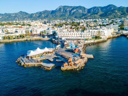 an aerial view of a resort in the water at DOME Hotel & Casino Central Kyrenia ! in Kérynia