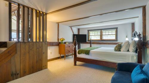 Una cama o camas en una habitación de Historic Barn Retreat w Pool Pond Views Longview Pond Lodge by AvantStay