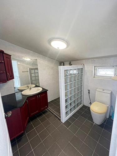 a bathroom with a toilet and a sink at Townhome 45 in Ban Nong Pru