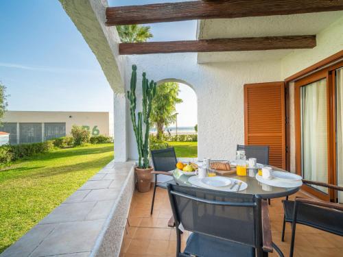 a patio with a table and chairs on a porch at Apartment Carabela Chic by Interhome in Alcudia