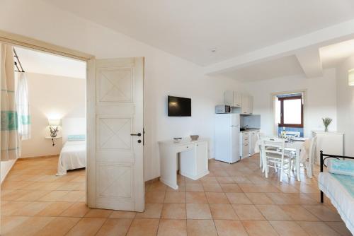 a living room with a door open to a kitchen at Baia dei Mirti 4 people Apartment in Vignola Mare