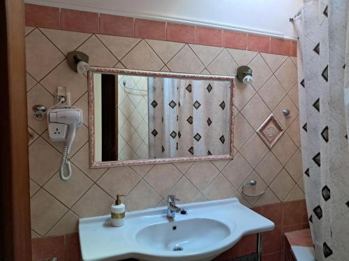 a bathroom with a sink and a mirror at Krista House in Agios Gordios