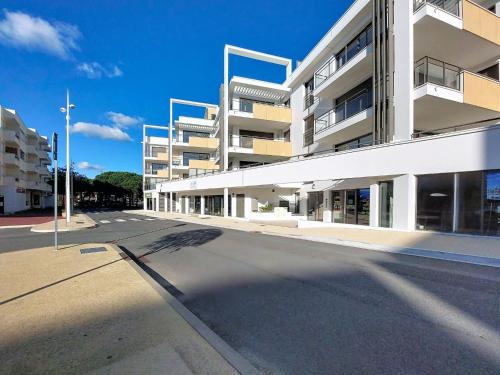 an empty street in front of a building at Apartment Veleda by Interhome in La Palmyre
