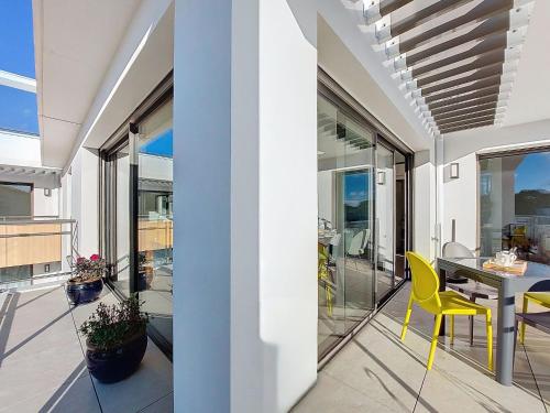a balcony with a table and yellow chairs at Apartment Veleda by Interhome in La Palmyre
