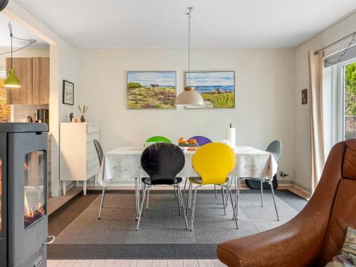 a living room with a dining room table and chairs at Holiday Home Paule - 1-3km from the sea by Interhome in Vesterø Havn
