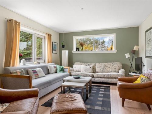 a living room with two couches and a table at Holiday Home Paule - 1-3km from the sea by Interhome in Vesterø Havn