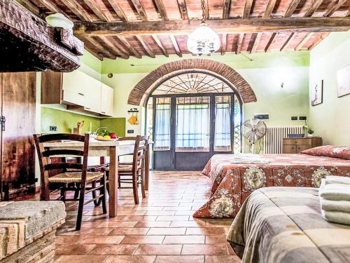 a bedroom with two beds and a table with chairs at Apartment Iris by Interhome in Venturina Terme