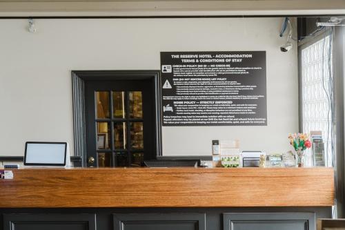 a sign on the wall of a restaurant at The Reserve Hotel in Sale
