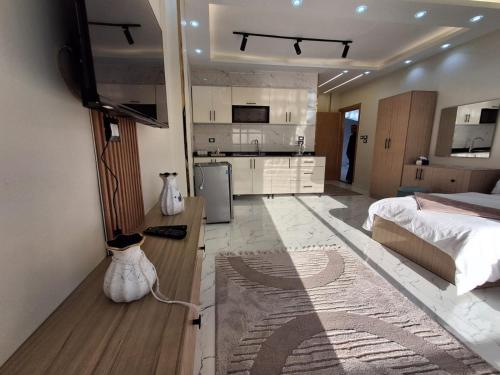 a large bedroom with a bed and a kitchen at ElMena House Luxor in Luxor