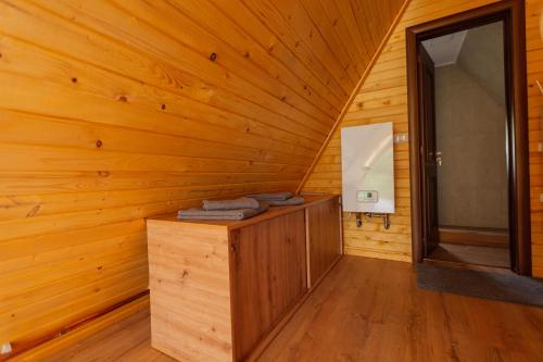 a wooden cabin with a sink and a mirror at Chilia Houses in Mănăstirea Humorului