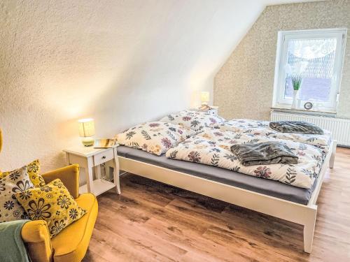 a bedroom with a bed and a chair and a window at Apartment Die Dorfperle by Interhome in Wanna