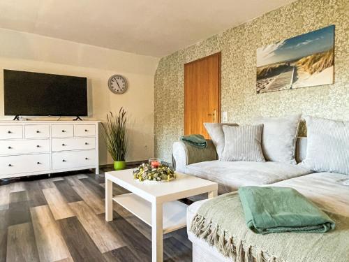 a living room with a couch and a tv at Apartment Die Dorfperle by Interhome in Wanna