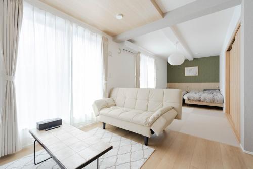 a living room with a couch and a bed at AMBLE Asakusa in Tokyo