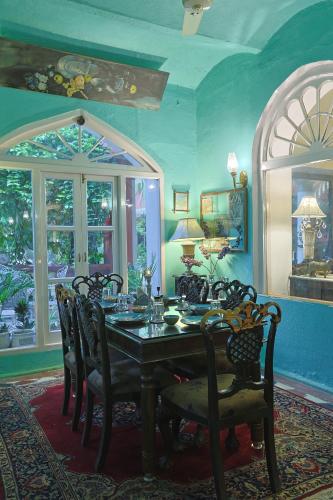 a dining room with a table and chairs at Ranjit's Svaasa Amritsar in Amritsar