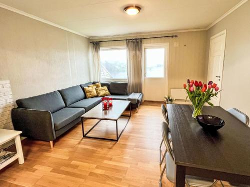 a living room with a couch and a table at Apartment Samlen Vasselgård by Interhome in Herand