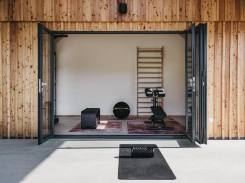 a room with wooden walls and a doorway with a yoga mat at Das Dietrich - Landhaus 62 in Leibnitz