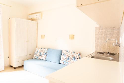 a kitchen with a bench next to a sink at Villa Nefeli Skiathos in Skiathos Town