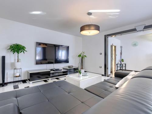 a living room with a couch and a table at Villa Elli by Interhome in Tinjan
