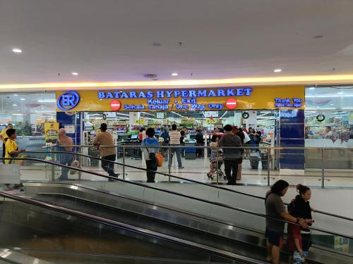 a group of people waiting for their luggage at an airport at Modern Home surrounded with many Amenities in Donggongon