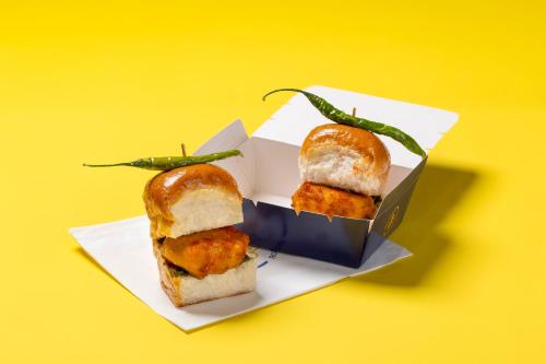 two sandwiches in a box on a yellow background at Round D Clock, IGI Airport in New Delhi