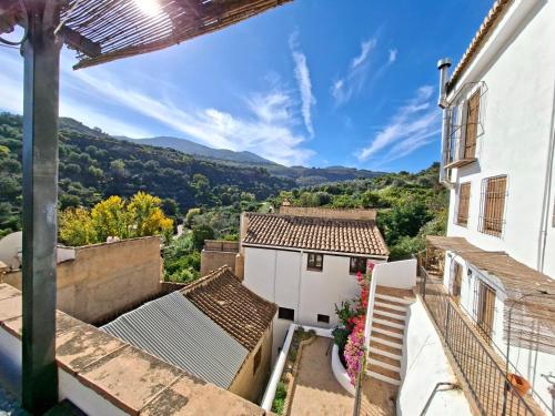 a view from the balcony of a house with mountains in the background at Casa Balcón in Granada